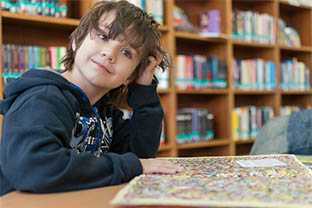 A child sitting in a library.