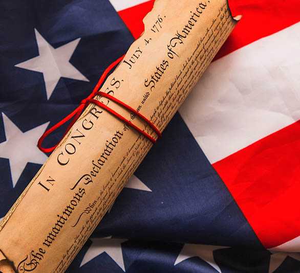 A photo of the American Flag and the Declaration of Independence.